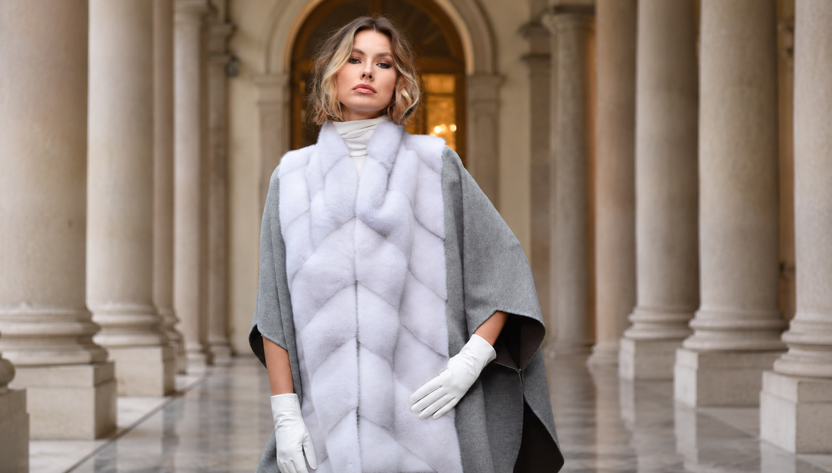 Woman wearing a cashmere cape with a mink chevron front panel