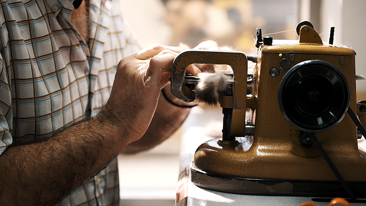 A furrier feeding a fur panel through the fur sewing machine in the Casiani workshop in Kastoria