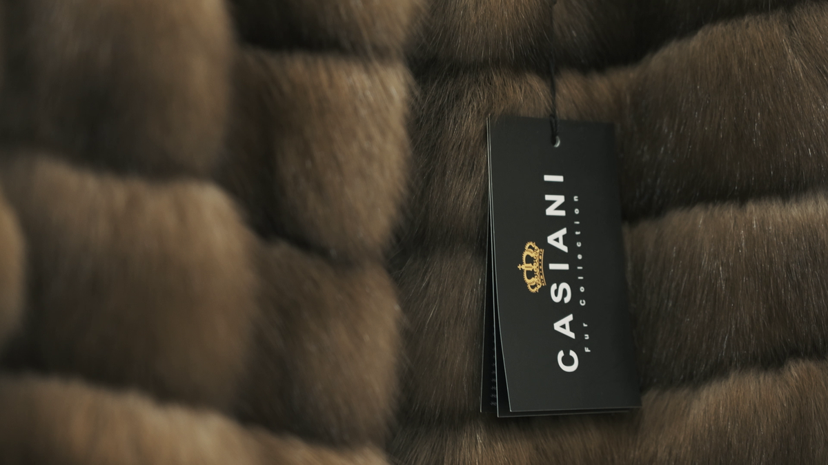 The black CASIANI hang-tag on a finished sable coat
